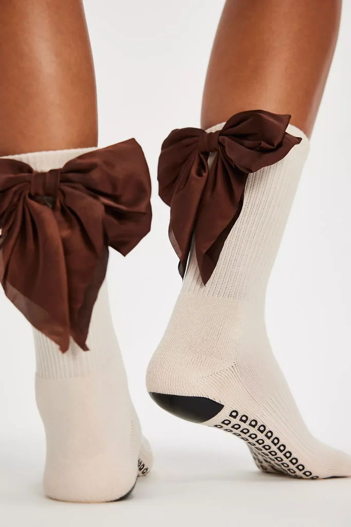 off white socks with grip bottom with a burgundy bow